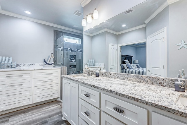 bathroom with ornamental molding, vanity, a shower with door, and wood-type flooring