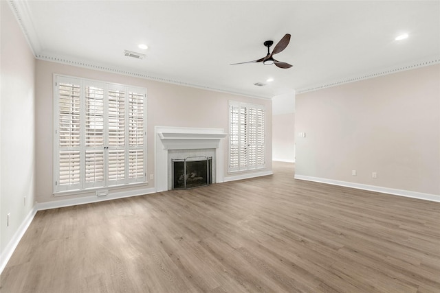 unfurnished living room with ornamental molding, ceiling fan, and light wood-type flooring