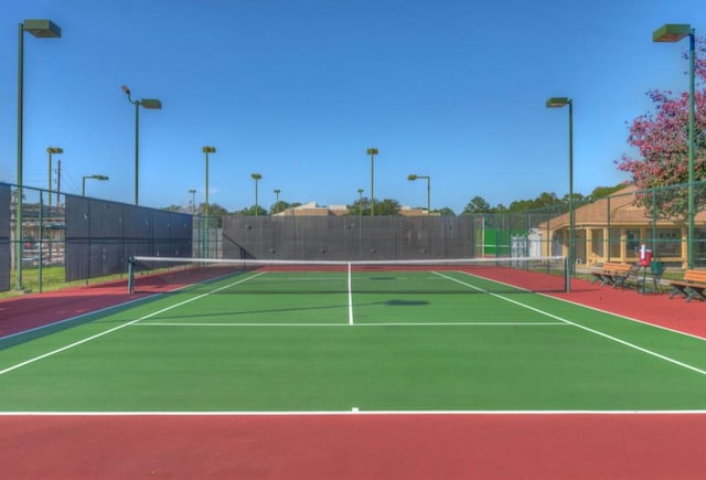 view of tennis court with basketball hoop