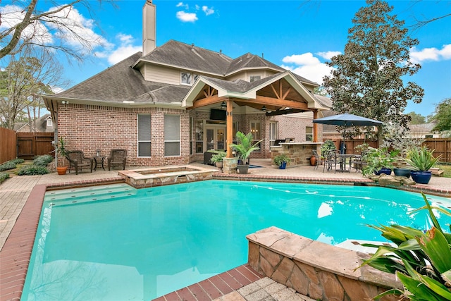 view of swimming pool with a patio area, an in ground hot tub, and exterior bar