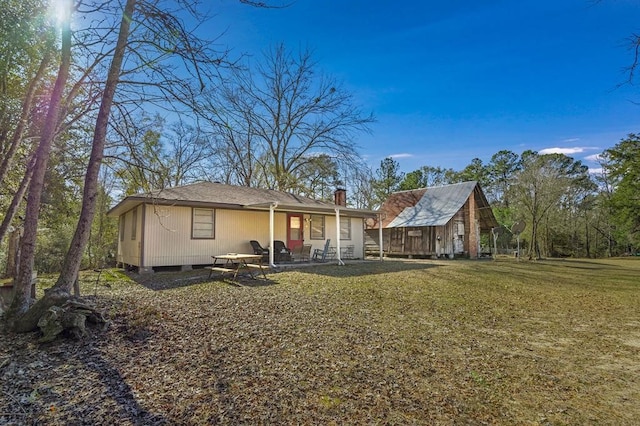 back of house with a yard