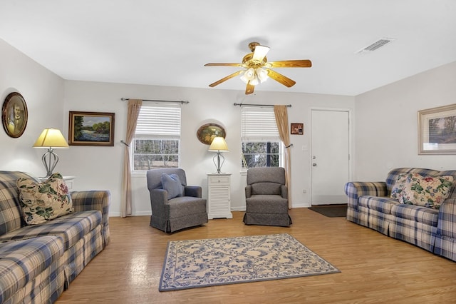 living room with ceiling fan, a healthy amount of sunlight, and wood-type flooring