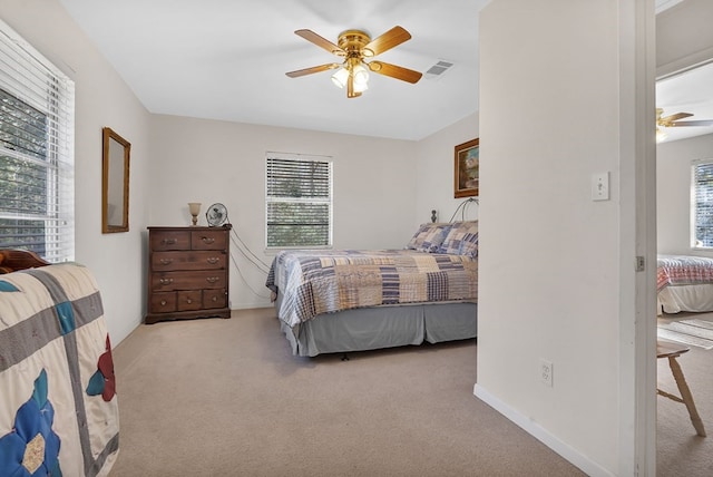 carpeted bedroom with ceiling fan