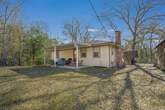 back of property featuring a lawn