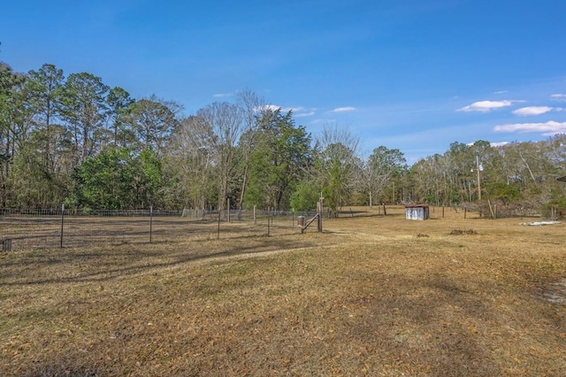 view of yard featuring a shed and a rural view