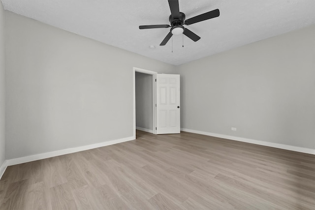 spare room featuring ceiling fan and light hardwood / wood-style flooring