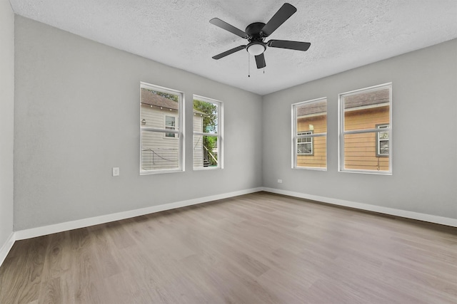 unfurnished room with hardwood / wood-style flooring, a textured ceiling, and ceiling fan