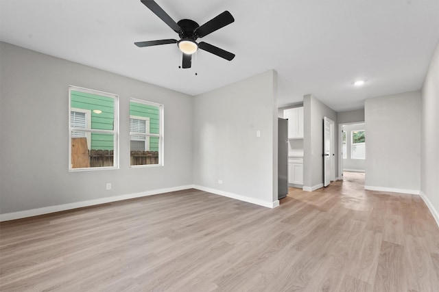 unfurnished living room with ceiling fan and light hardwood / wood-style floors