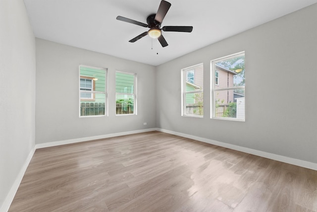 empty room with light hardwood / wood-style floors and ceiling fan