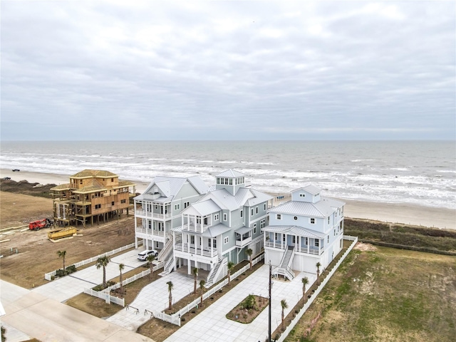 aerial view with a water view and a view of the beach