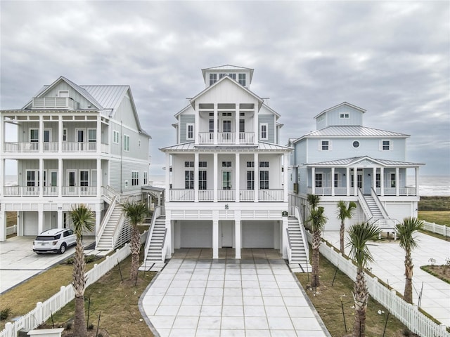 beach home featuring a garage, a balcony, and a porch