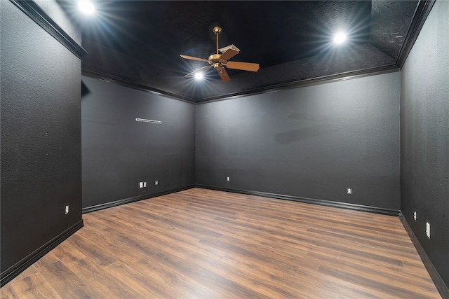 unfurnished room with dark wood-type flooring, ceiling fan, and ornamental molding