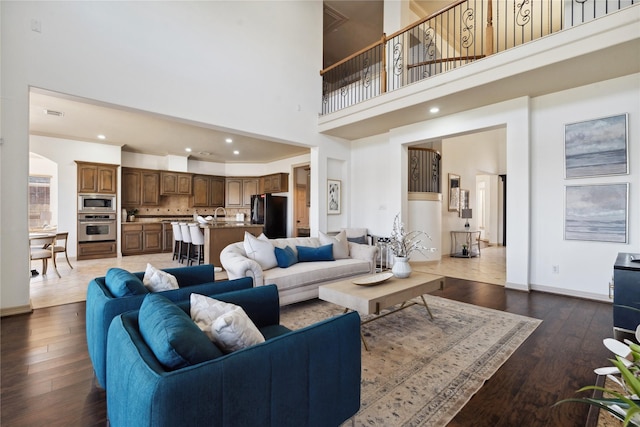 living room featuring dark hardwood / wood-style floors and a high ceiling