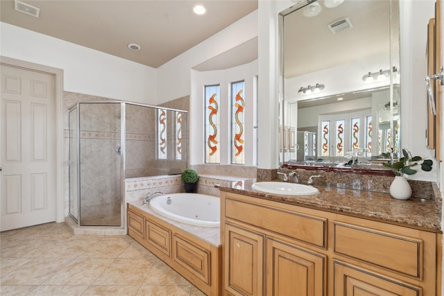 bathroom with tile patterned flooring, shower with separate bathtub, and vanity