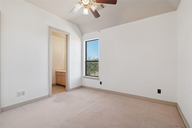 unfurnished bedroom with light carpet, connected bathroom, vaulted ceiling, and ceiling fan