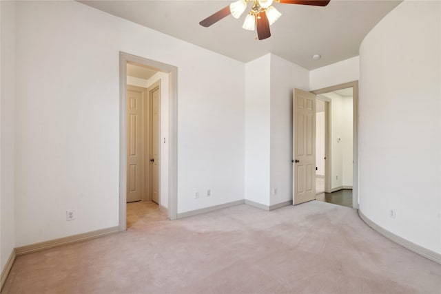 unfurnished bedroom featuring ceiling fan and light colored carpet