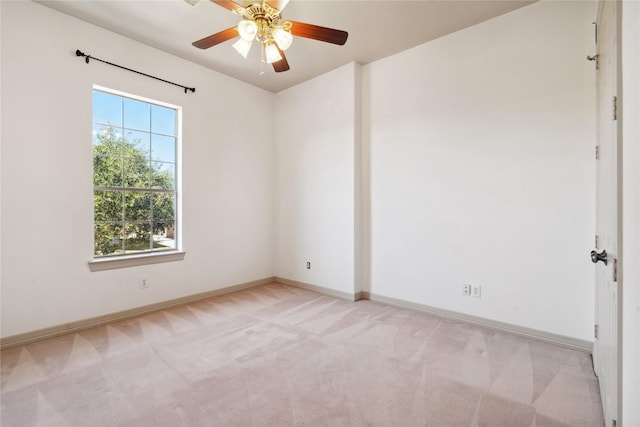 empty room featuring light carpet and ceiling fan