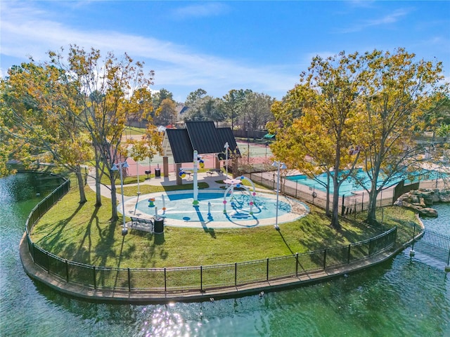 view of swimming pool featuring a water view and a lawn