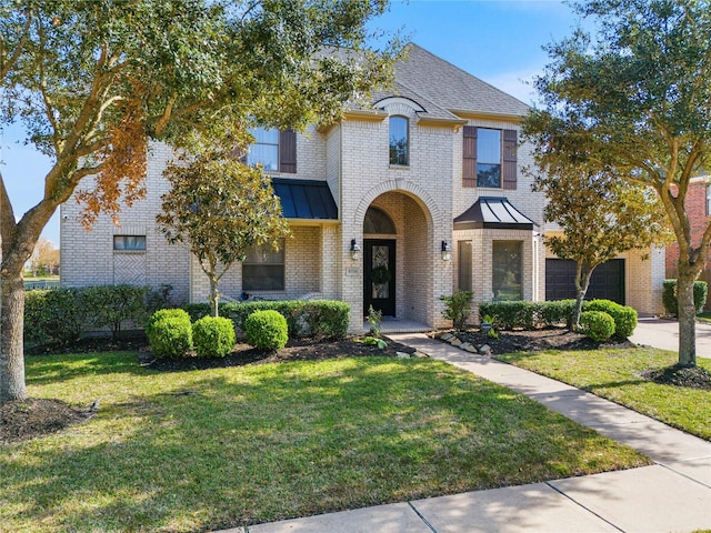 view of front of house with a garage and a front yard