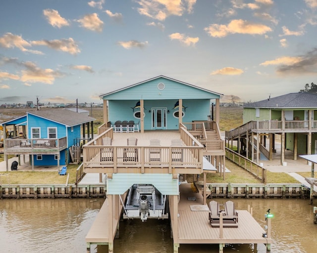 back of property with a deck with water view