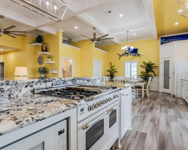 kitchen with white cabinetry, light stone counters, white appliances, and light hardwood / wood-style flooring