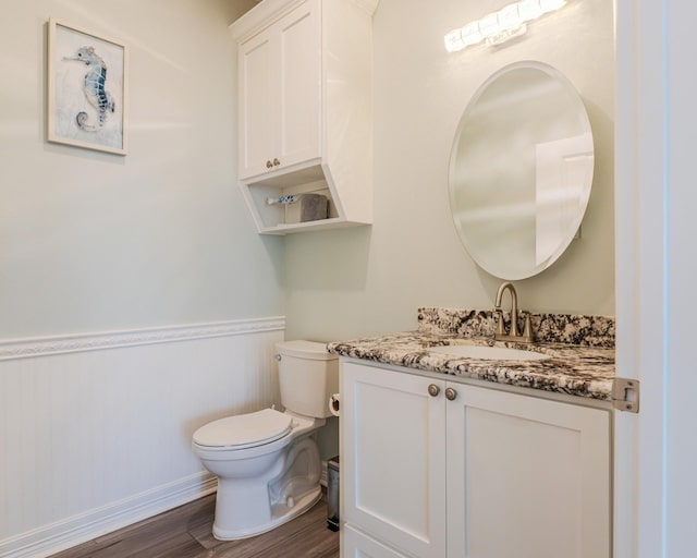 bathroom with vanity, hardwood / wood-style floors, and toilet