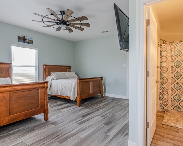 bedroom with ceiling fan and light hardwood / wood-style flooring