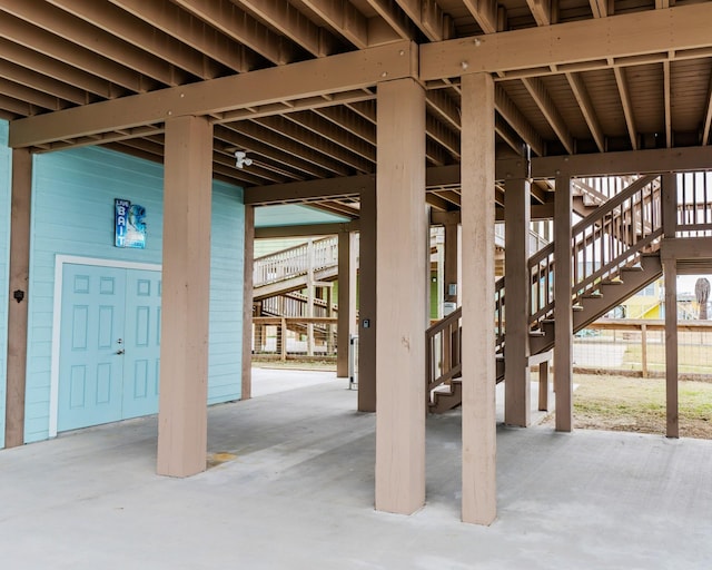 miscellaneous room with concrete flooring and wooden walls