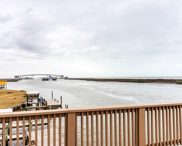 view of dock with a deck with water view