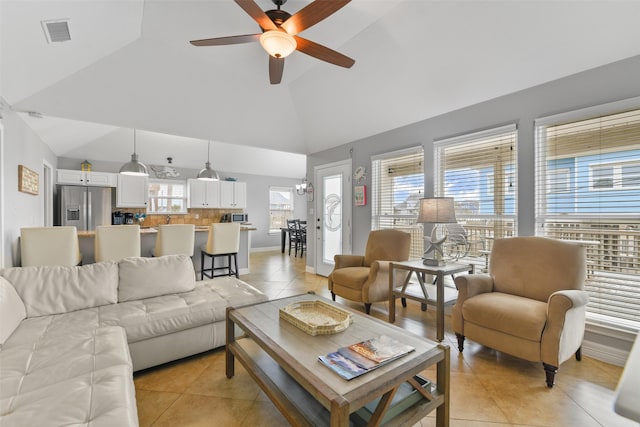 tiled living room featuring high vaulted ceiling and ceiling fan