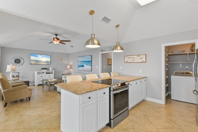 kitchen featuring electric stove, washer / dryer, pendant lighting, and white cabinetry