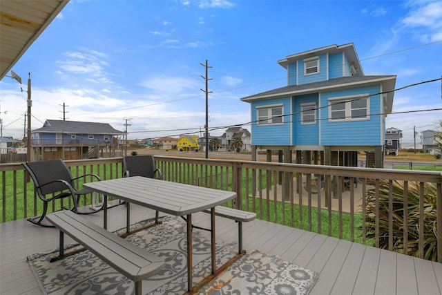 wooden terrace with a lawn