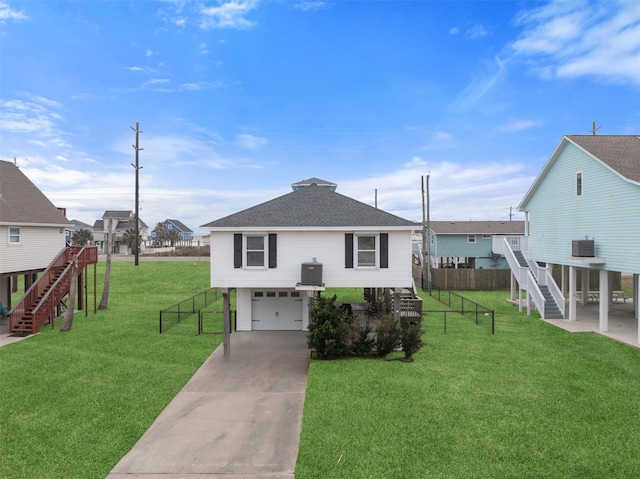 exterior space with a garage, a front yard, and central air condition unit