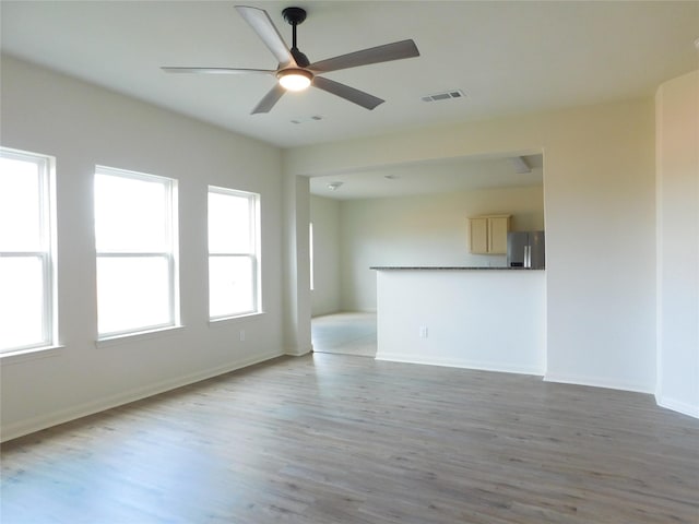 unfurnished living room with ceiling fan, plenty of natural light, and light hardwood / wood-style floors