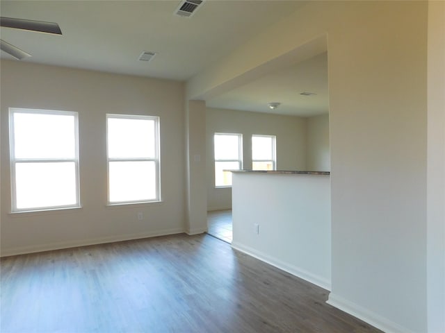 empty room featuring ceiling fan and wood-type flooring