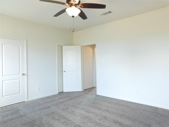 spare room featuring light colored carpet and ceiling fan