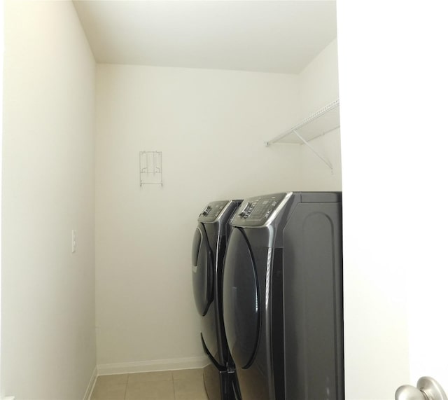 laundry room with separate washer and dryer and light tile patterned floors