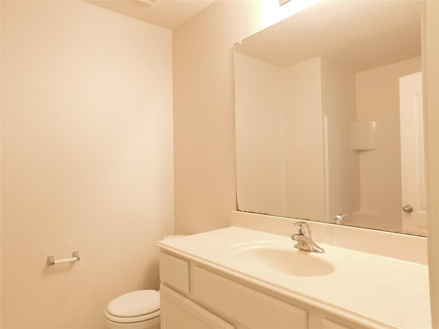 bathroom featuring vanity, toilet, and tile patterned flooring