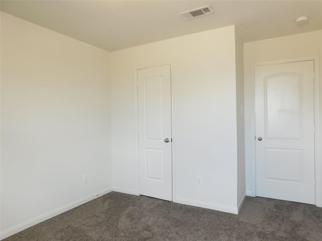 unfurnished bedroom featuring dark colored carpet