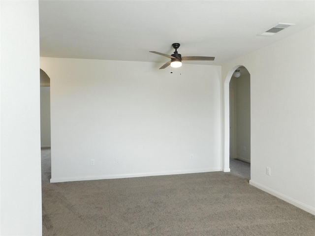 carpeted spare room with ceiling fan