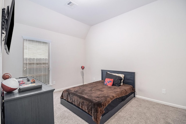 bedroom featuring lofted ceiling and light colored carpet