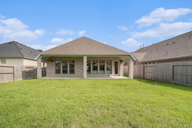 back of house featuring a yard and a patio area