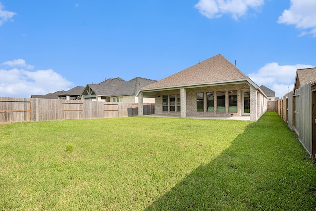 rear view of house featuring a lawn