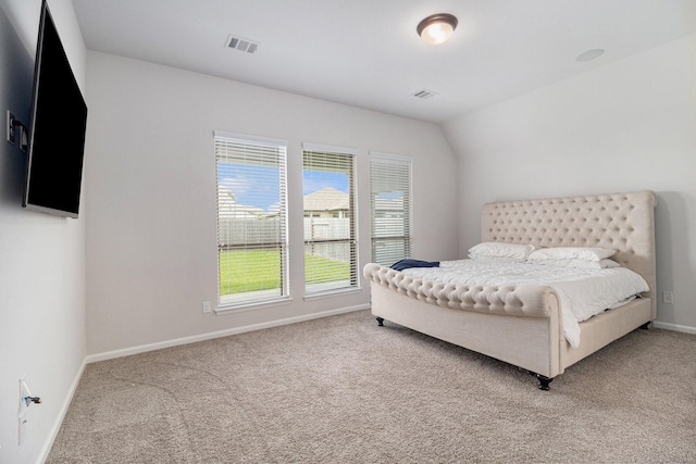 bedroom featuring vaulted ceiling and carpet