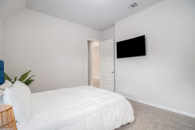 bedroom featuring lofted ceiling and carpet flooring