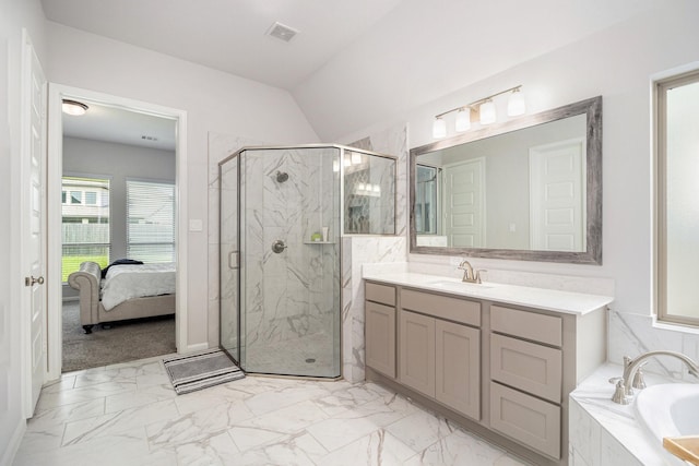 bathroom with independent shower and bath, vaulted ceiling, and vanity