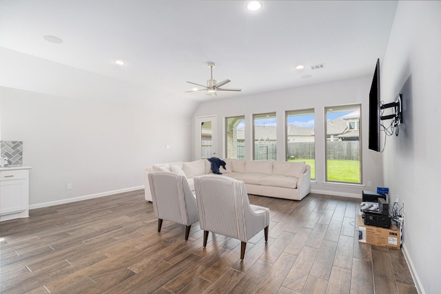 living room with ceiling fan and vaulted ceiling