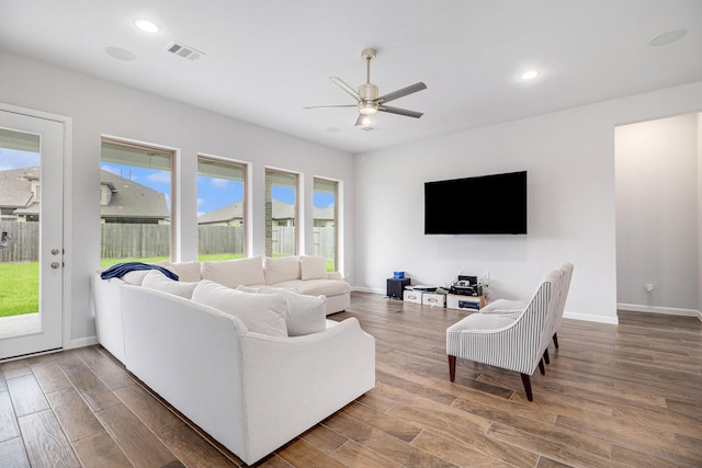 living room featuring ceiling fan and a healthy amount of sunlight