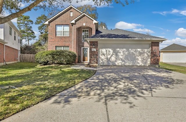 view of property with a garage and a front yard