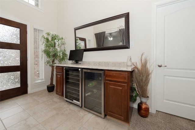 bar featuring wine cooler and light tile patterned floors